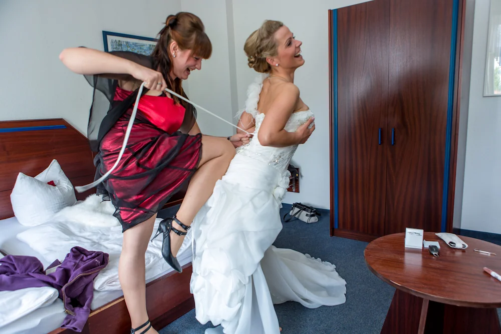 Mit viel Humor wird das Brautkleid geschnürt – Hochzeitsreportage von Delf Zeh